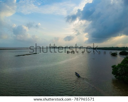 a boat at sea with beautiful cloudy sky