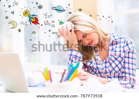 Idea Rocket with young woman with crumpled paper balls