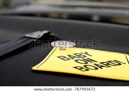 Yellow baby on board sign in the car