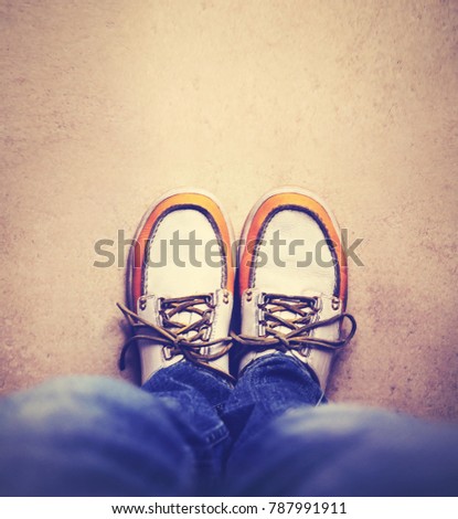 wide angle shot of yellow and white boat or deck shoes done with a retro vintage filter 
