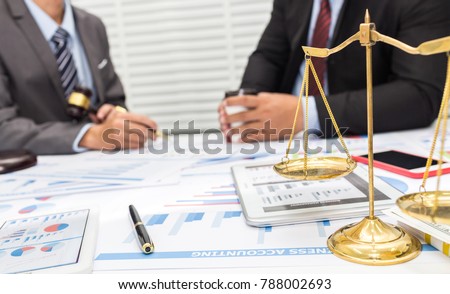 Colleagues are discussing issues related to lawsuits and counseling to fight lawsuits in court. Royalty-Free Stock Photo #788002693