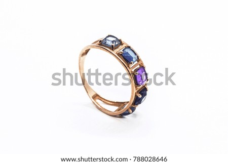 Gold ring with precious stones isolated on white