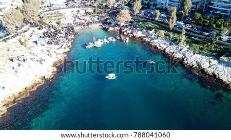 Aerial drone bird's eye view photo of iconic tradition of epiphany ceremony as seen from distance in picturesque small bay of Afrodite or Baikoutsi with small chapel, Piraeus, Attica, Greece