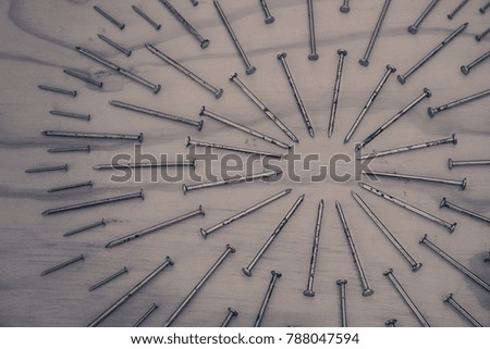 Photograph of some Metal nails in geometric composition