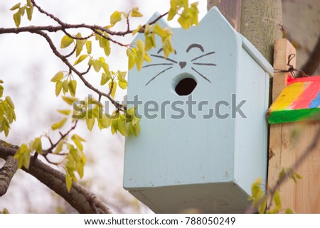 simple wooden bird house in a park