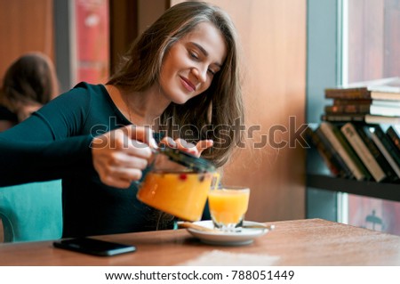 girl pours tea in a cafe