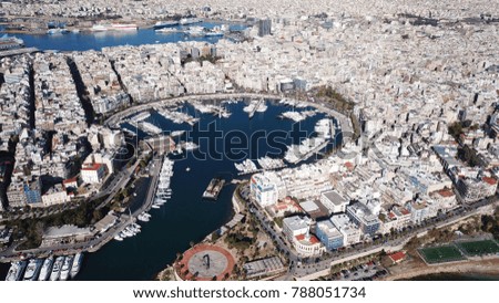 Aerial drone bird's eye view photo of iconic round shaped port of Marina Zeas with boats docked next to port of Piraeus, Attica, Greece