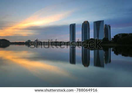 Beautiful sunset with buildings and water in dam in Putrajaya