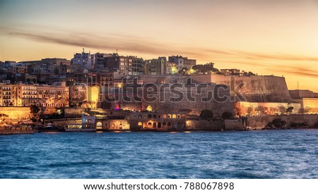 Malta: city walls of Valletta and Marsans Harbour at sunset