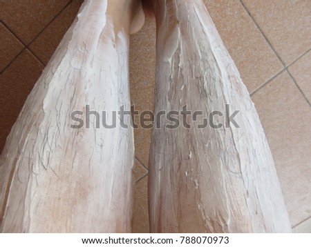 Applying Sensitive Hair Removal Cream on the legs for unwanted hair removing at home