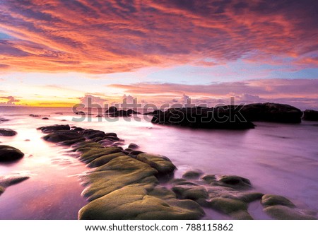Vibrant sunset seascape for background purpose. image contain soft focus and blur due to long expose and water movement.