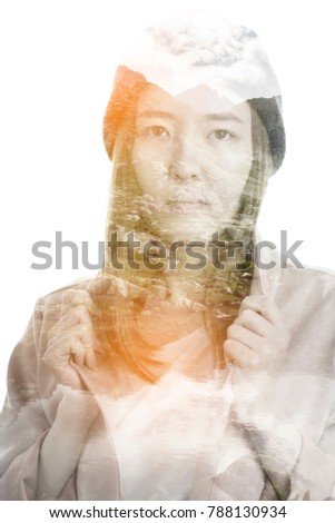 Portrait of a young woman with the effect of double exposure. Combination of a picture of mountains and a young woman.