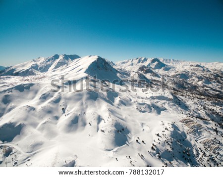Aerial photo of snowy mountain summit in winter