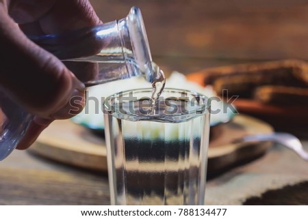 the vodka is poured into a glass. Royalty-Free Stock Photo #788134477