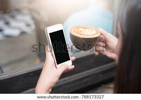 Close up of woman using mobile smart phone,sending massages on the garden.having sunbath.Phone with black screen,texting,video calls,
