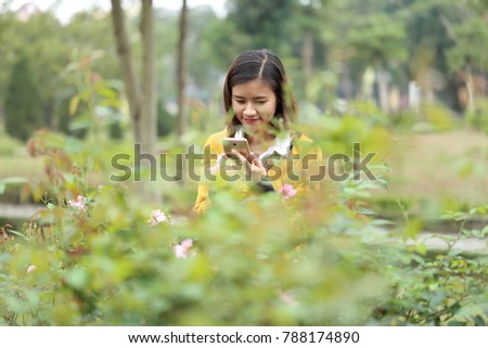 The woman taking photos of flower with smartphone