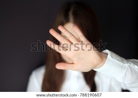 Woman's hand showing reject or stop gesture. Woman Closes the Face with Her Hand