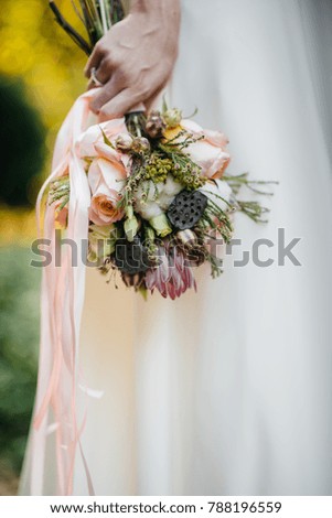 A beautiful, gentle wedding bouquet near the bride in the hands of a close-up. Wedding.