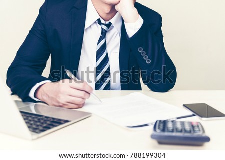 Successful business man thinking analyzing documents and finance statistics or discussing ideas. Exhausted business people falling a thinking at his office desk,entrepreneur,sad frustrated stressed 