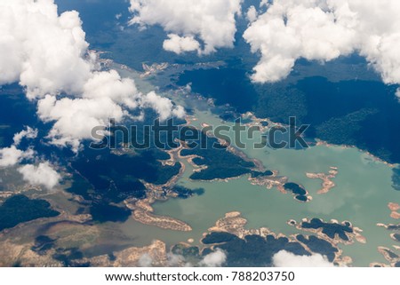 Aerial view from airplane window with forest and river