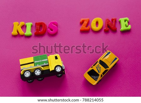 words "kids zone" with toy cars on pink background