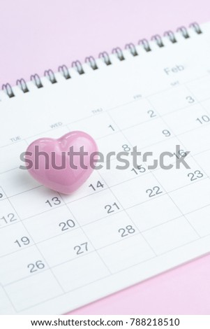 Calendar with cute pink heart shape on 14 February on pink background using as romantic Valentines day concept.