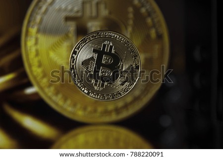 Golden bitcoin on blurred background picture with coins
