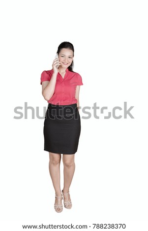 Image of Caucasian businesswoman speaking on the smartphone while standing in the studio