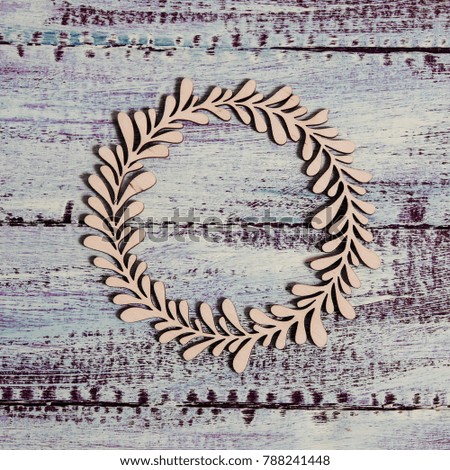 Circle with floral ornament  on shabby wooden background.  Mock up. Decorative wreath.
