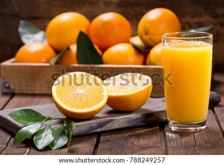 glass of fresh orange juice with fresh fruits on wooden table Royalty-Free Stock Photo #788249257