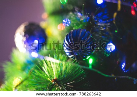 New Year's green branches of a fir-tree, with cheerful multi-colored toys.
