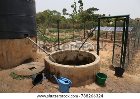 View of a water solar pumping system. The infrastructures are used to take out water from the ground and store it in a tank. The picture has been taken in a rural area of Guinea Bissau in Africa.