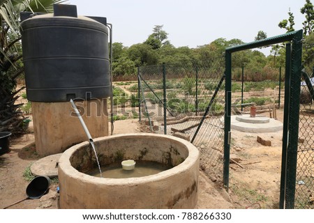 View of a water solar pumping system. The infrastructures are used to take out water from the ground and store it in a tank. The picture has been taken in a rural area of Guinea Bissau in Africa.