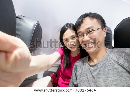 couple selfie and smile happily in airplane
