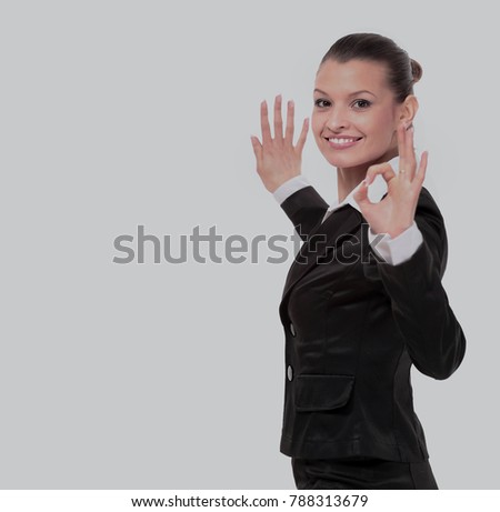 Attractive business woman is showing okay sign with happiness.