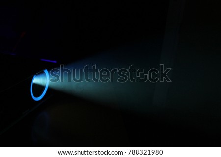 Blue rays of light through the smoke from the projector. Lighting equipment. Show, performance, concert or night club. Abstract Background