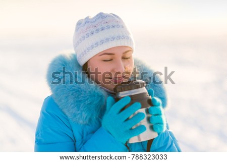 winter photo. girl with thermos