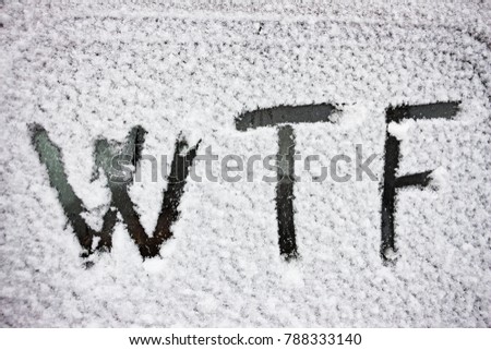 WTF inscription written on snow - covered glass
