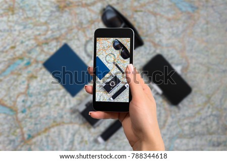 Composition with smartphone, passports and tickets on world map background. The photo is taken with telephone