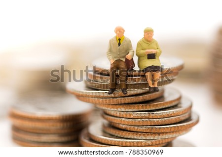 Miniature people, Old couple figure sitting on top of stack coins using as background retirement planning, Life insurance concept. Royalty-Free Stock Photo #788350969