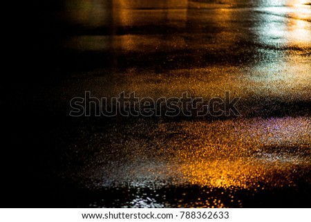 abstract yellow pavement, photographed at night, rainy street