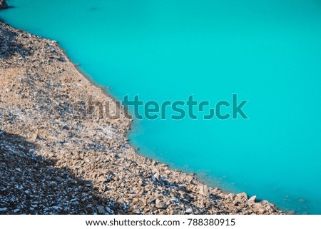 Beautiful blue water in mountain lake. Travels in the mountains