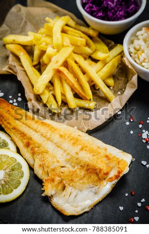 Fish dish - fried fish fillet french fries and vegetables