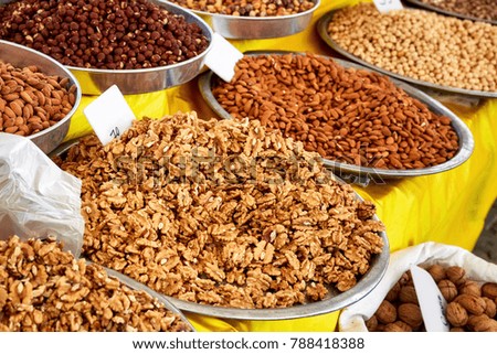 Pile of walnut kernel, almond and nut in round metal trays in an authentic bazaar