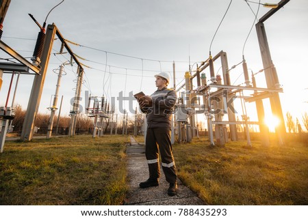 The energy engineer inspects the equipment of the substation. Power engineering. Industry. Royalty-Free Stock Photo #788435293