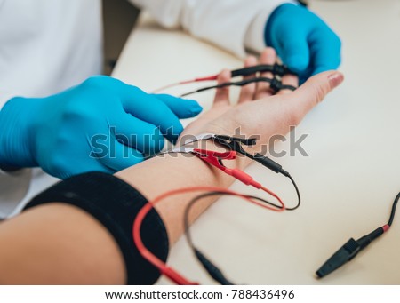 Patient nerves testing using electromyography. Medical examination. EMG Royalty-Free Stock Photo #788436496