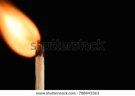 The moment the flaring match with a bright flame on black background closeup