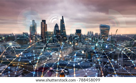 City of London at sunset with communication icons and network lines Royalty-Free Stock Photo #788458099