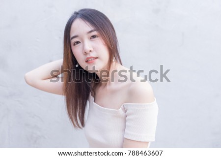 Young Asian beautiful and pretty woman wearing open shoulder dress, off the shoulder or cutout dress with smile and happy emotion