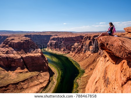 Tourist at Horseshoe Bend on Colorado River in Glen Canyon, Arizona, USA Royalty-Free Stock Photo #788467858